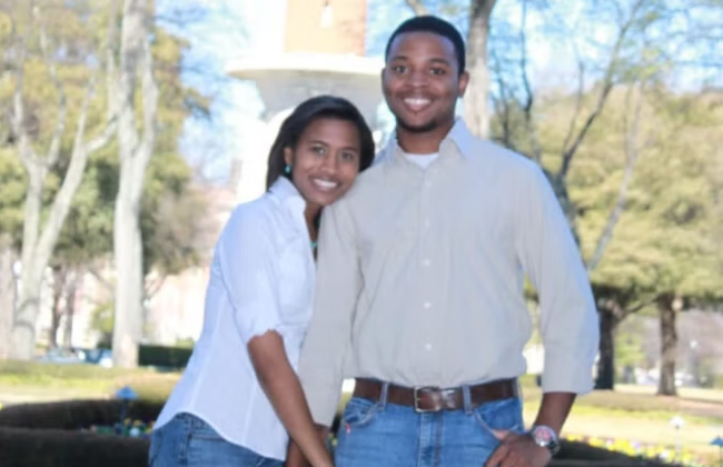 Ben and Alyson Baxter pose smiling near Denny Chimes